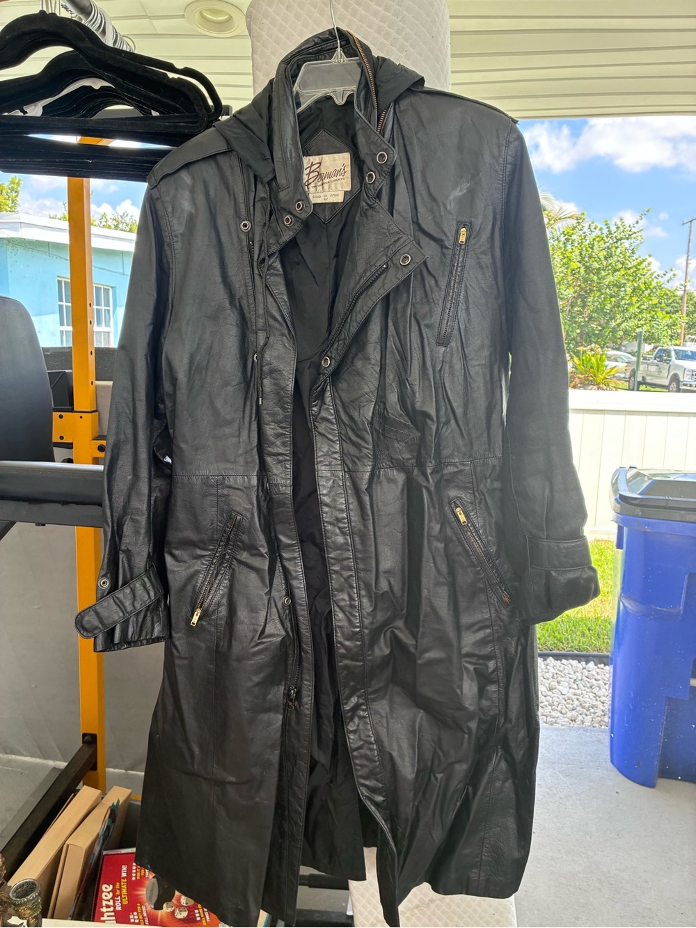 Black Hooded Leather Trench Coat by Bruno Marc